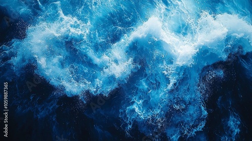 Aerial view of turbulent ocean waves in deep blue hues.