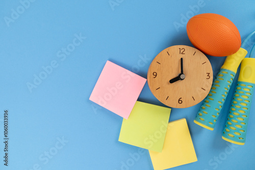 Time for exercising clock and exercise equipment with blue background, sport and healthy concept photo