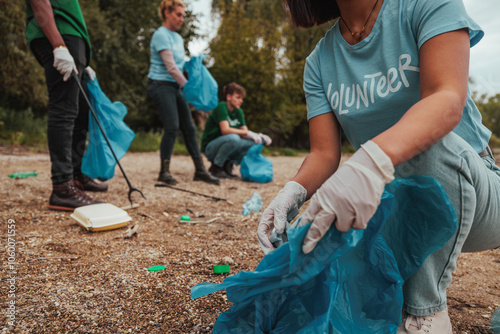 Volunteers picking up trash in polluted park