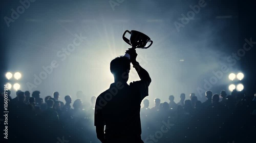 Silhouette of a woman holding a trophy in a stadium, with dramatic lighting highlighting her triumphant pose. video