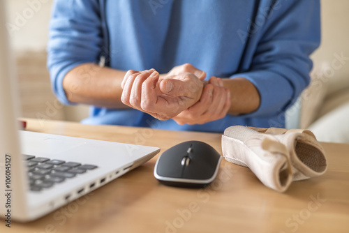 Professional With Wrist Pain From Continuous Typing At Home Office Due To Tendonitis And Carpal Tunnel Syndrome, Showing Repetitive Stress And Workplace Injury Risks
