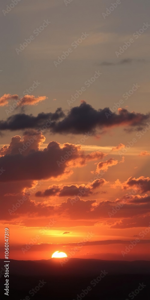 Fototapeta premium A breathtaking sunset with clouds casting a warm glow over the evening sky, natural, peaceful, sky