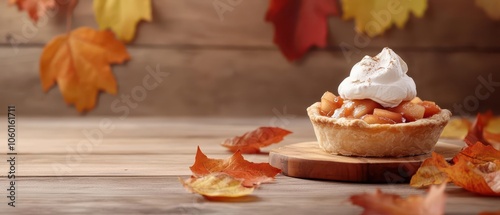 Rustic apple pie with a scoop of vanilla cream, served beside scattered autumn leaves photo