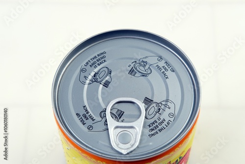 Close-up of a metal can with a pull-tab lid and opening instructions. The circular design highlights the convenience of canned food packaging, ideal for topics on storage, convenience, or food safety.