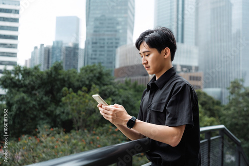 Asian business man concentrating on looking at his phone