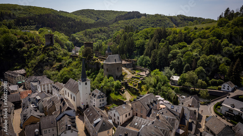 Aerial view of Esch-sur-Sure, medieval town in Luxembourg, dominated by castle, canton Wiltz in Diekirch. Forests of Upper-Sure Nature Park, meander of winding river Sauer, near Upper Sauer Lake.