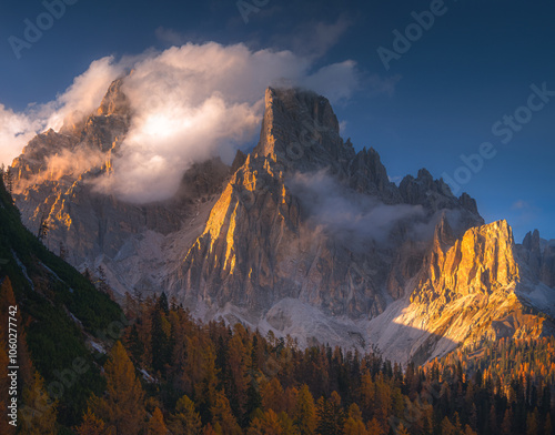 Sunlit Mountain Peak Amidst Clouds