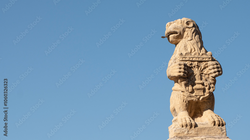 Stone lion sculpture with heraldic shield in the city of Segovia (Spain) Stone lion sculpture with heraldic shield in the city of Segovia (Spain)