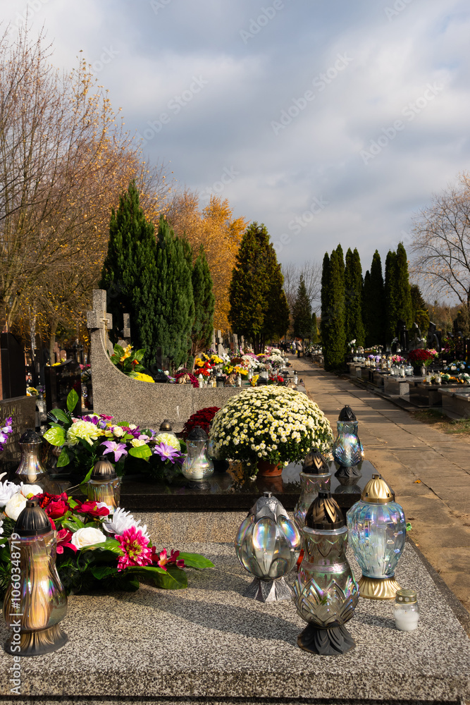 Graves with candles during the All Souls' Day celebration on November 1st. Photo taken during the day in natural light