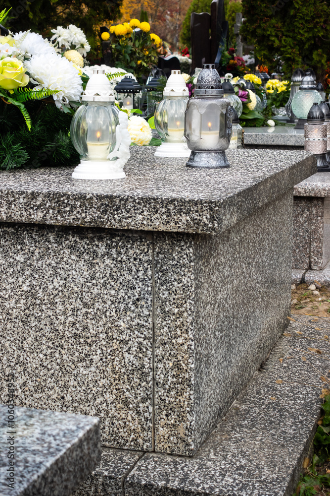 Graves with candles during the All Souls' Day celebration on November 1st. Photo taken during the day in natural light