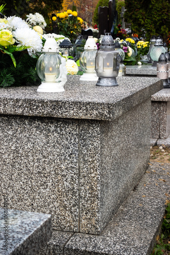 Obraz na płótnie Graves with candles during the All Souls' Day celebration on November 1st. Photo taken during the day in natural light w salonie