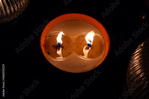 Obraz na płótnie Flames on clay cemetery candles standing on tombstones. The shot was taken in the evening of All Saints' Day, November 1. w salonie