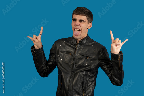 young rocker heavy metal man isolated on blue background photo