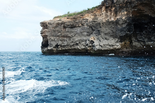 Landscape of rocky cliff at the sea and destination travel seascape on summer ocean in Bali island at Indonesia