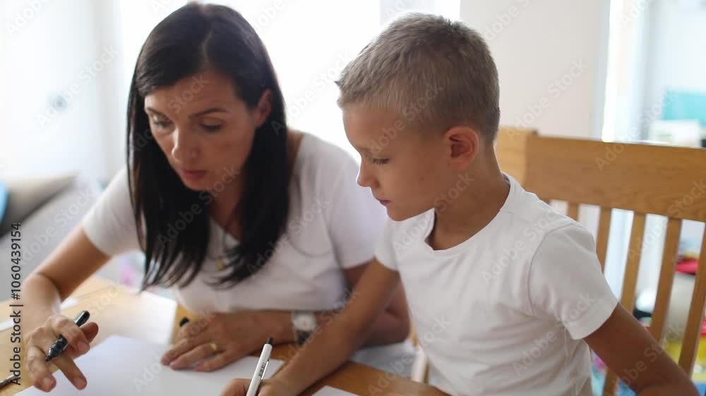 Boy studying with his mother Boy studying with his mother