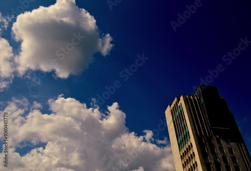 Clouds in the sky reaching toward the building embarks the ambition. photo