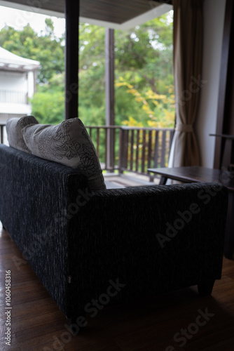 Modern gray toned sofa bed in hotel room with curtain and carpet decorate in earth tone photo