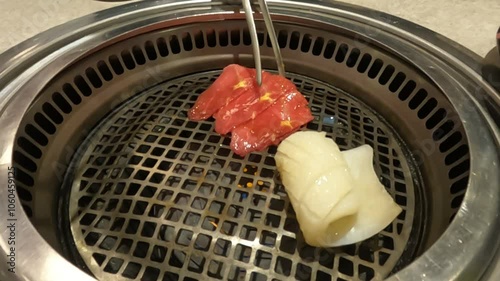 close up of sliced meat and squid fillet in the grill