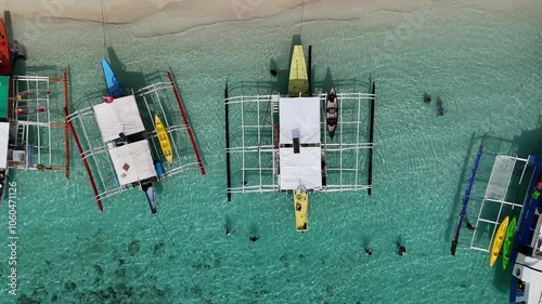 Stunning Aerial View of a Small Lagoon with Filipino Boats, a White Sand Beach, and Lush Green Mountains with Gorgeous Cliffs in the Philippines – High-Resolution 4K