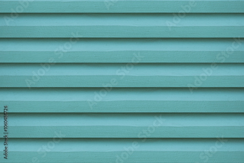 The close-up of the green wooden vent lattice, highlights its intricate design, providing a vibrant background.