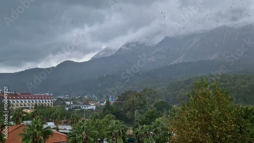 View from the balcony of the hotel on the fog, mountains. Morning or evening cloudy sky with heavy rain