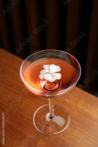 Cocktail with peach liqueur, wine and vanilla flower petals. photo