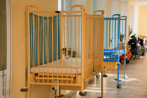 Empty baby cribs in a bright, inviting nursery hallway