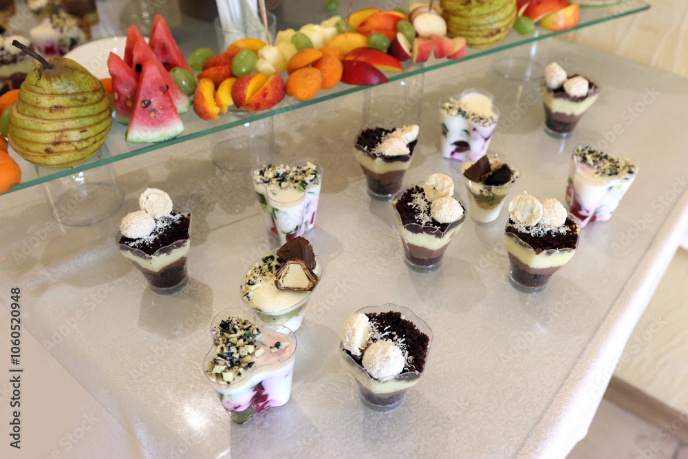 Naklejka premium Pastries, mousses and various sweets for the festive buffet table.