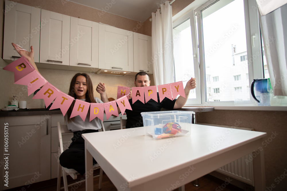 Father and daughter prepare decorations for the holiday, crafting garlands at home, enjoying family fun Father and daughter prepare decorations for the holiday, crafting garlands at home, enjoying family fun
