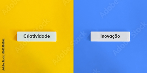 Creativity versus Innovation Words and Concept Image. Text on Block Letter Tiles on Yellow and Blue Background. Minimal Aesthetic.