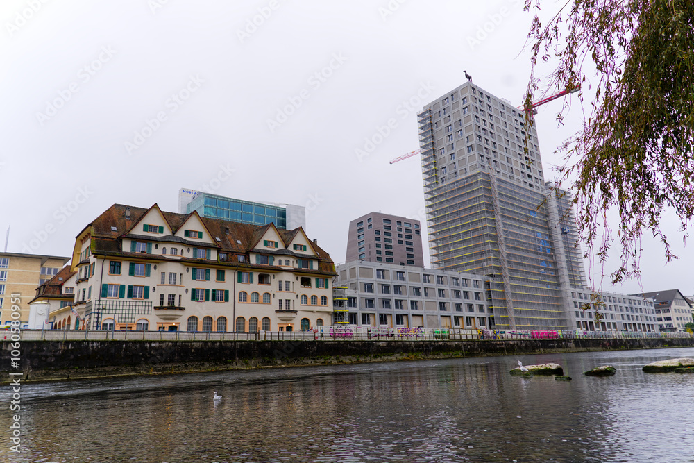 Fototapeta premium Scenic view of Limmat River with skyline at industrial district of Swiss City of Zürich on a foggy autumn day. Photo taken November 2nd, 2024, Zurich, Switzerland.