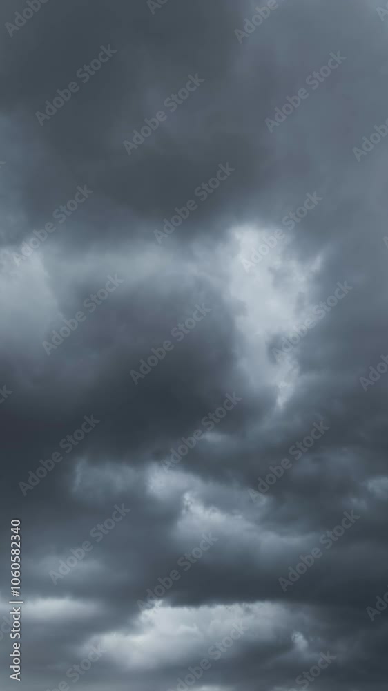 Dramatic dark storm clouds are moving fast. Vertical video