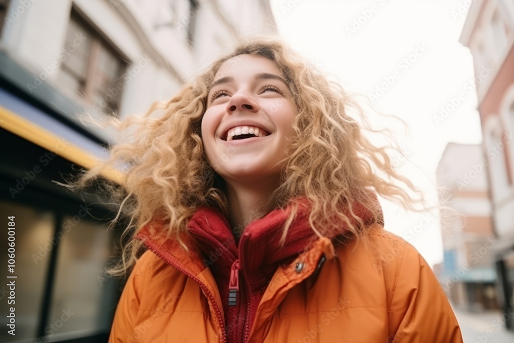 Portrait of beautiful young woman with blond curly hair in yellow jacket Portrait of beautiful young woman with blond curly hair in yellow jacket