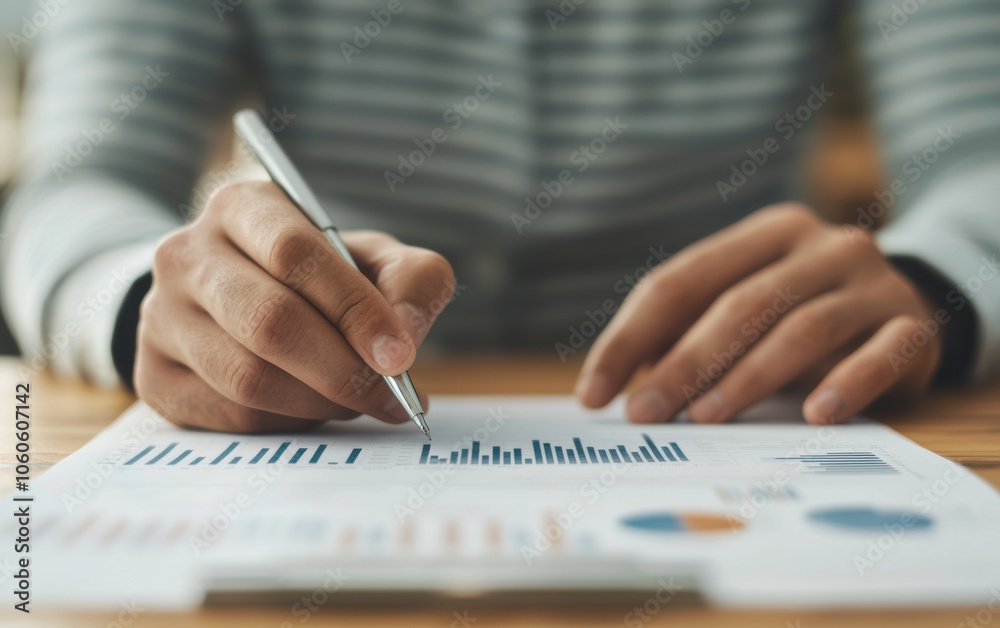 person analyzing business growth charts and writing notes person analyzing business growth charts and writing notes