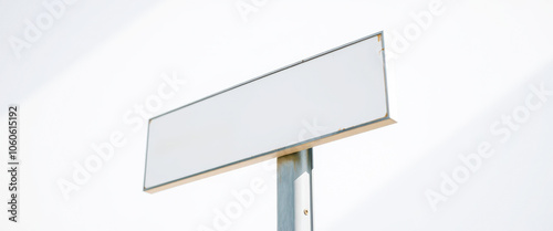 blank white sign mounted on a metal pole photo