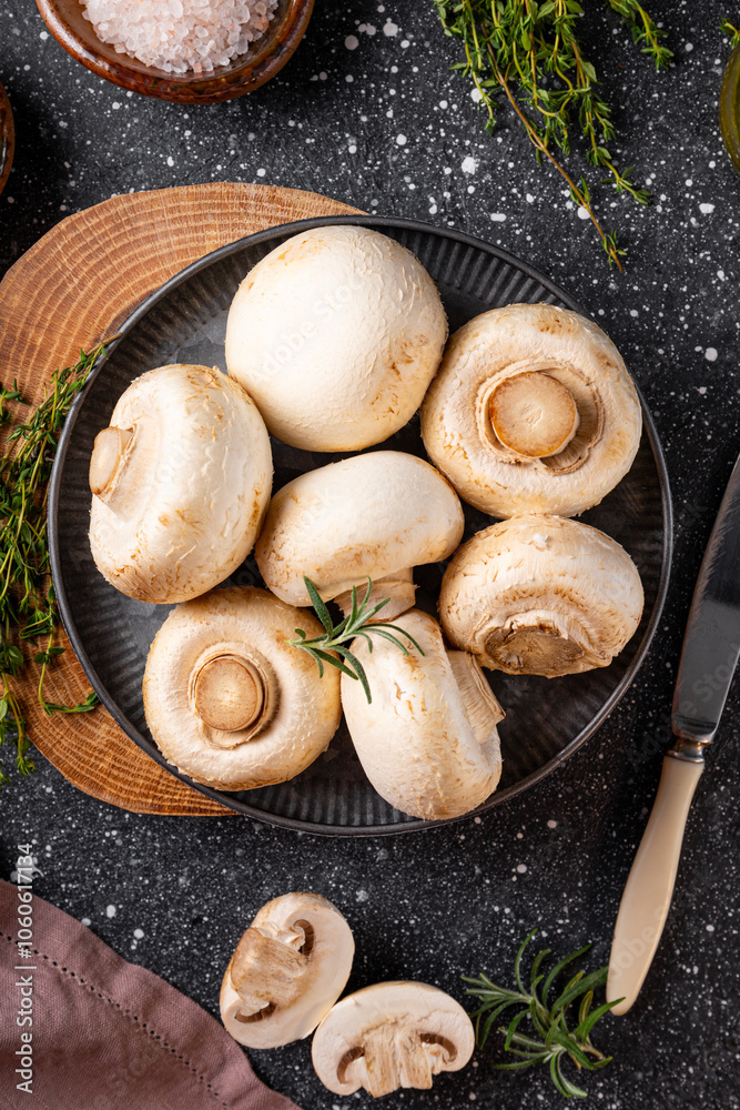 Fresh raw champignon mushrooms on gray background vertical photo Fresh raw champignon mushrooms on gray background vertical photo