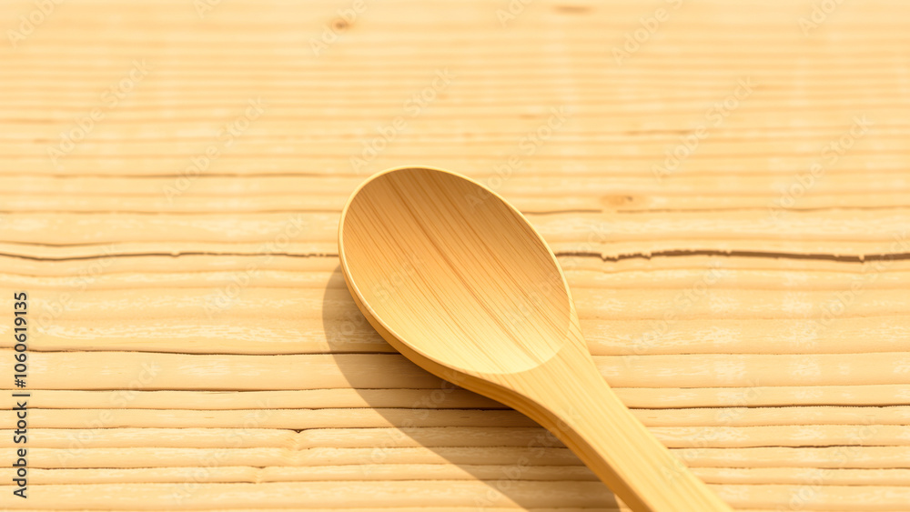 simple wooden spoon resting on a wooden surface simple wooden spoon resting on a wooden surface