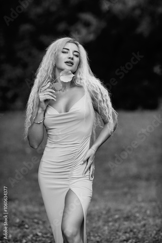 Portrait of a young beautiful blonde girl in nature. Black and white photo.