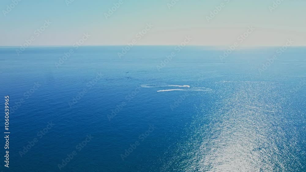 Clear blue ocean water under the bright sun against a tranquil sky