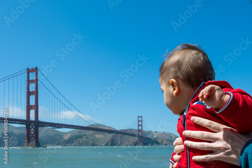 Baby Gazing at Golden Gate Bridge with Parent's Support in San Francisco
