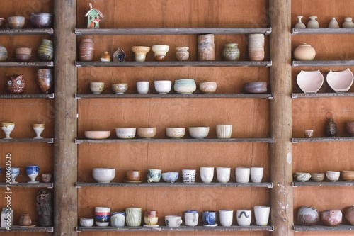 Wallpaper Mural Brown shelves with colourful pottery pieces Torontodigital.ca