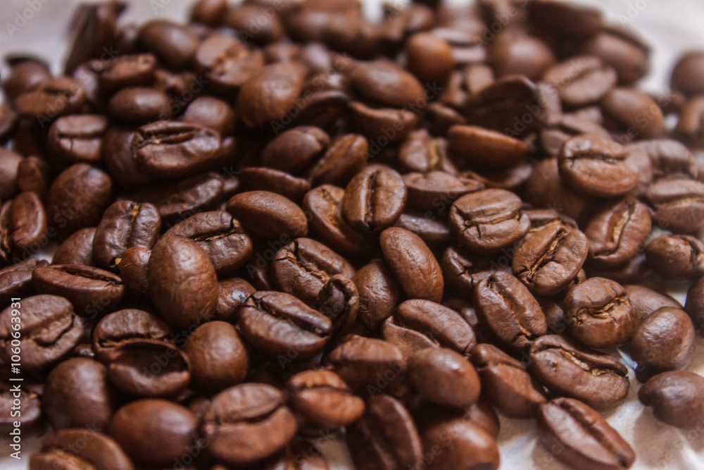 Coffee beans artistic shot, brown bean, arabica and robusta, café, caffeine, white background, freshness, shot is selective focus with shallow depth of field, taken at Cairo Egypt Coffee beans artistic shot, brown bean, arabica and robusta, café, caffeine, white background, freshness, shot is selective focus with shallow depth of field, taken at Cairo Egypt