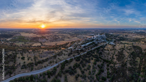 Amazing aerial view of the medieval village of Monsaraz, Alentejo, Portugal. Beautiful landscape at sunset. Historic castle, tourist attraction and holiday travel destination.