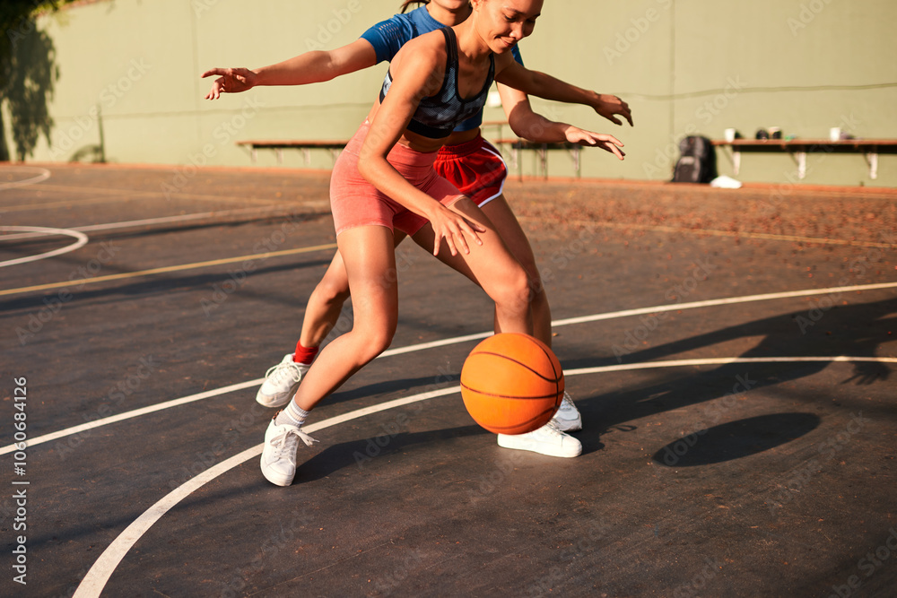 Fototapeta premium Outdoor, basketball and women playing game together for competition, challenge and fitness on playground. Fun, sports and girl friends on court with ball, exercise and teamwork at community club