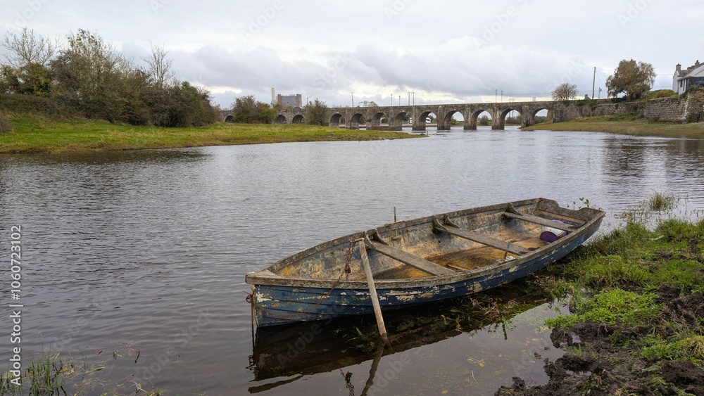 Old wooden fishing boat in river Shannon at Shannonbridge, Offaly, Ireland, nature background