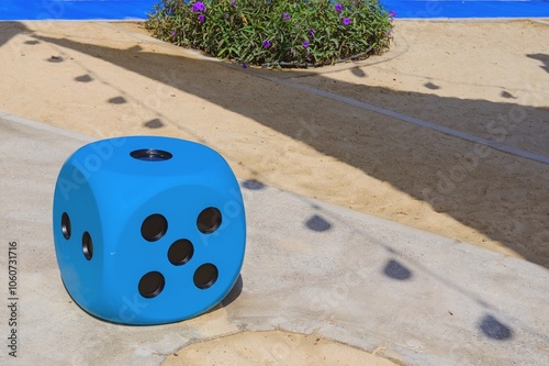  Blue huge gambling cube as a creative decision for urban furniture. Oversize giant blue dice shaped chair with five dots for game at the playground.
