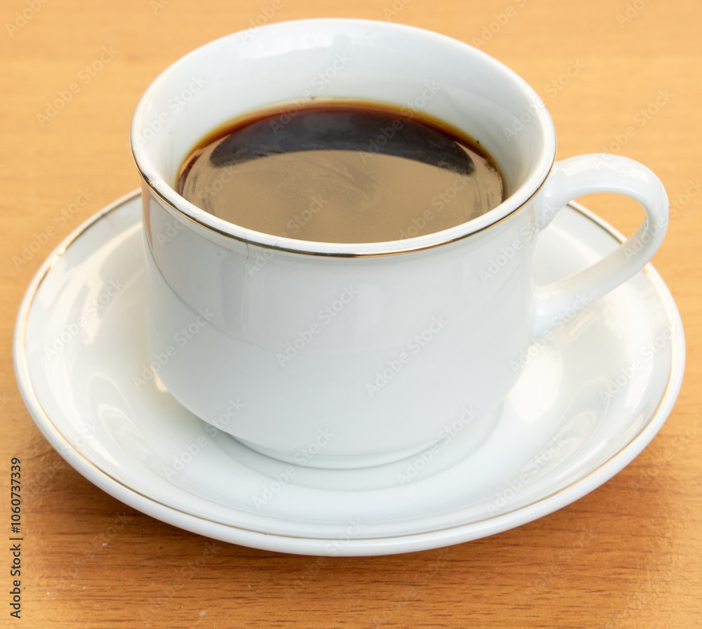 Obraz premium Black Coffee in Ceramic Cup on Wooden Table