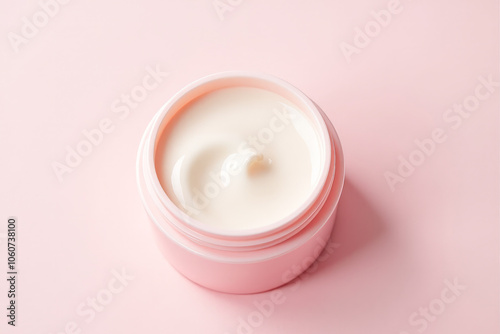 an open jar of skin moisturizer on a pink background , top view, side view, close-up