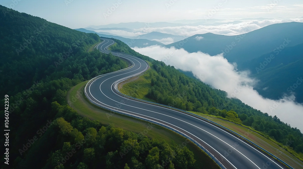 winding highway through lush green mountains, surrounded by clouds and mist, creates serene and picturesque landscape. road curves gracefully, inviting exploration winding highway through lush green mountains, surrounded by clouds and mist, creates serene and picturesque landscape. road curves gracefully, inviting exploration