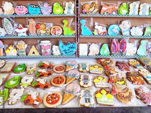 Colorful decorated cookies displayed in a bakery during a sunny afternoon photo